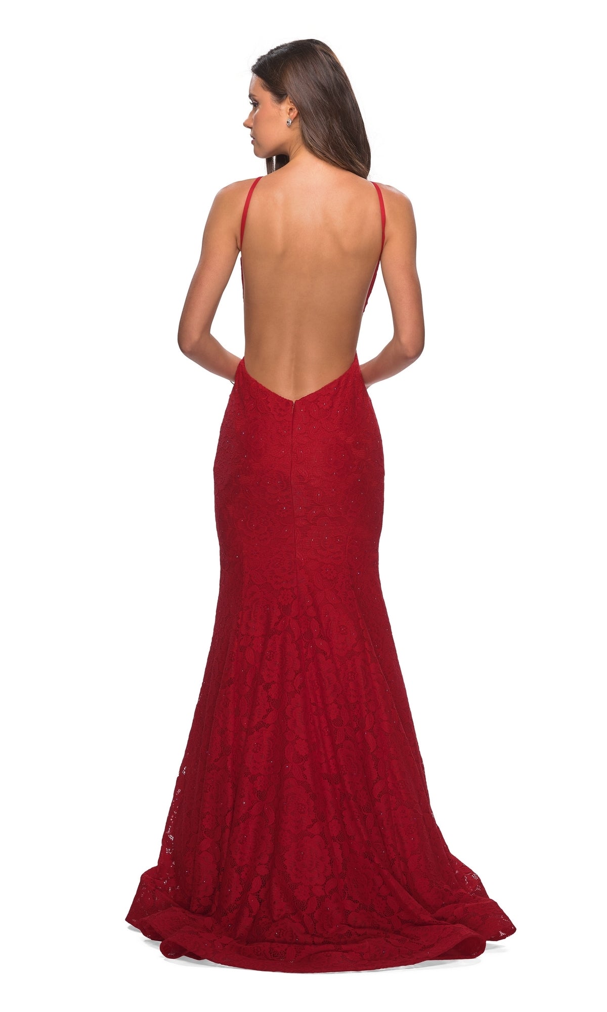 A woman, seen from behind, wears the La Femme Floral Lace Mermaid Prom Dress 27289—a floor-length red gown with thin straps, floral lace detail, and an open low V-back.